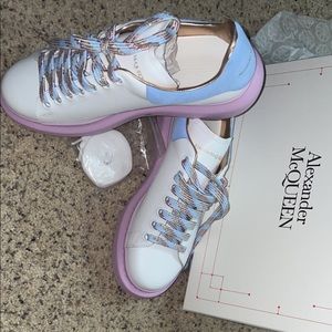 White with lilac and blue trim Alexander McQueen sneakers.